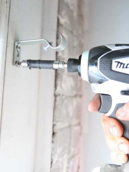 Help with using drill to make holes on wall to install a curtain rod.